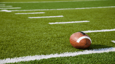 A football sitting on a football field