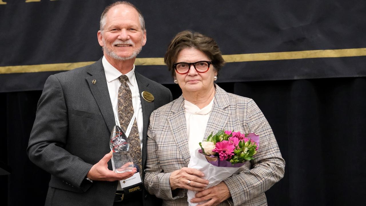 Ewa Matuszewski, MedNetOne founder/CEO and SHS Board member, receiving an award from the SHS Dean